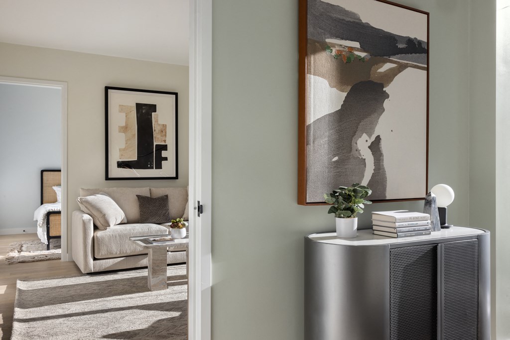 a living room with a couch and a table and a radiator at The Paxton, Brooklyn, New York